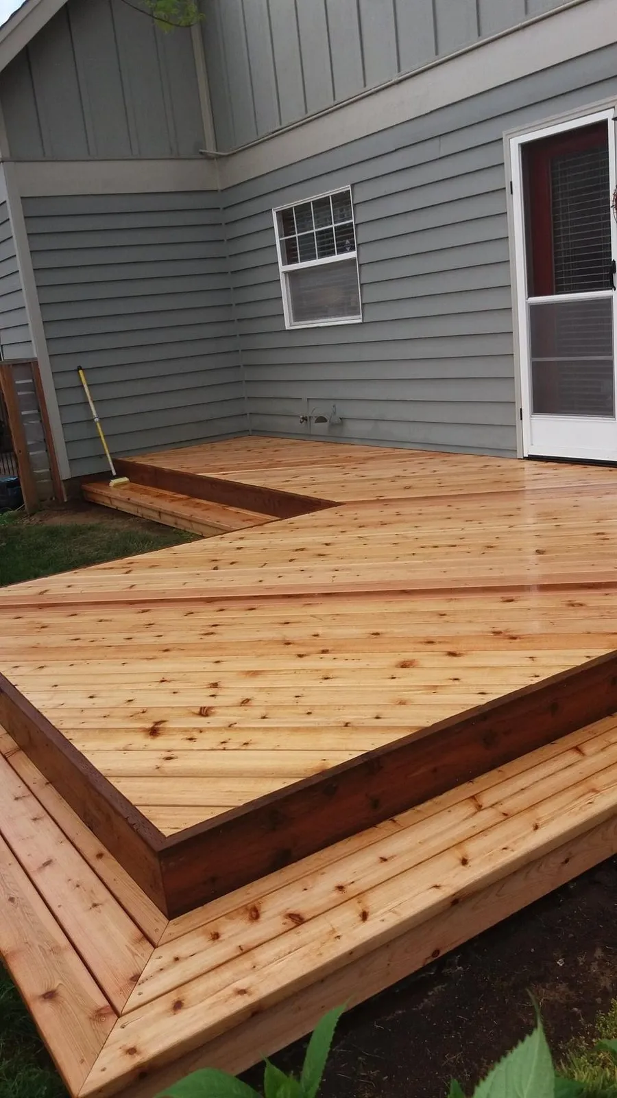 Stepped wood deck edge against the house siding