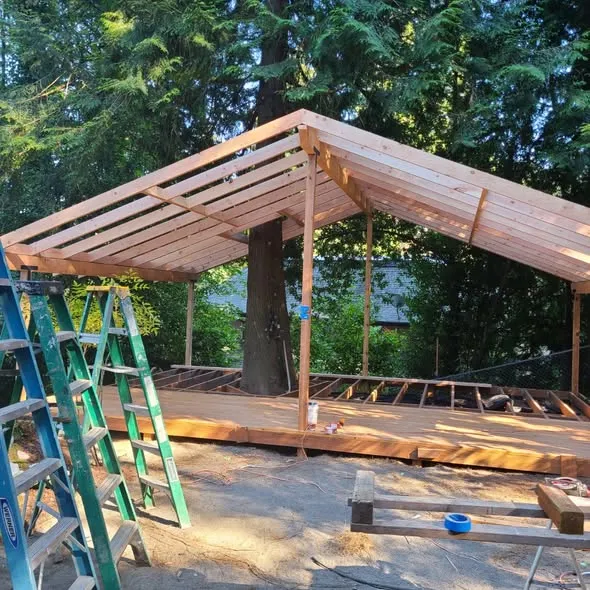 Pergola rafters going up over the new deck frame