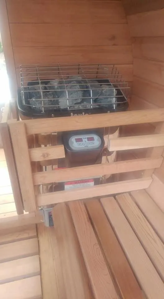 Sauna interior with an electric heater and wood benches