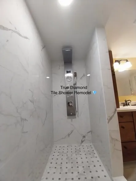 Finished tile shower with linear drain and mosaic floor