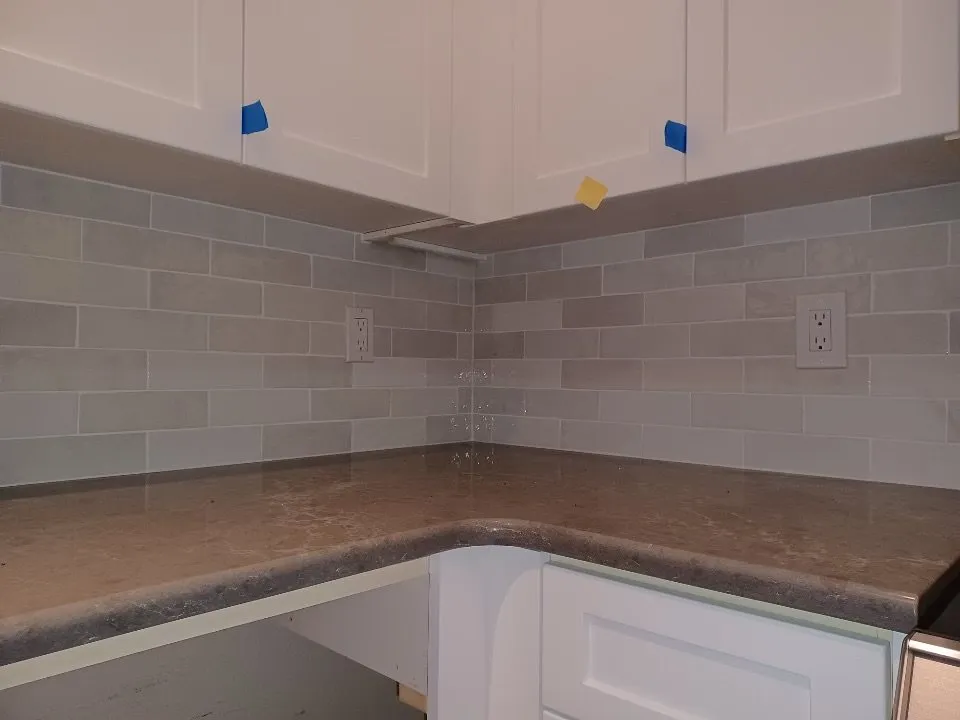 Gray subway tile backsplash in a kitchen corner