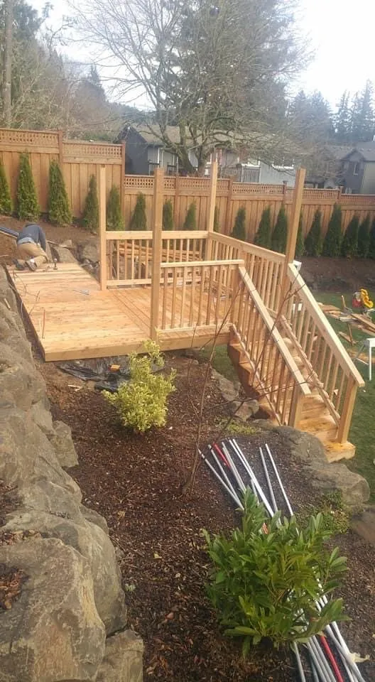 Railed wood walkway through a landscaped garden