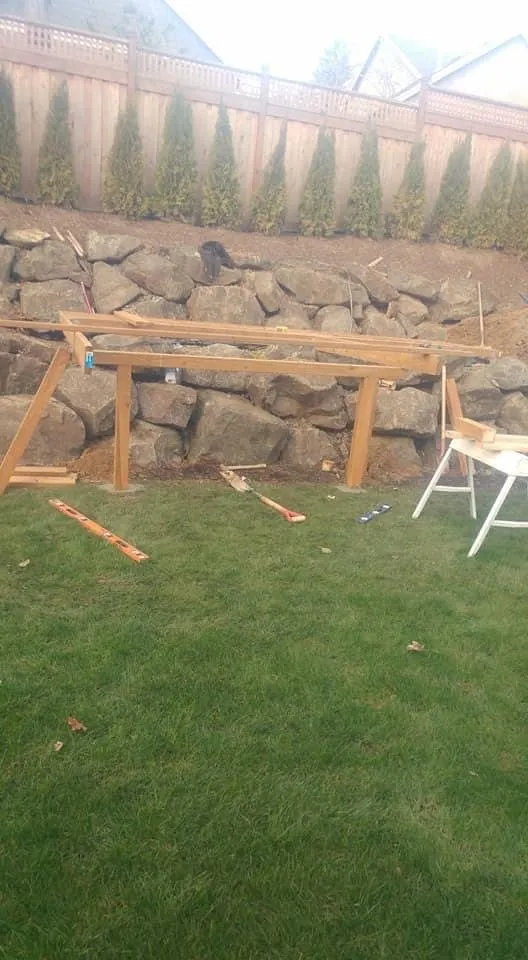 Sauna platform framing next to a rock wall